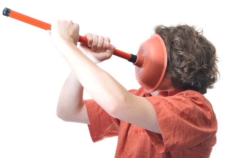 A beginner plumber having trouble with a toulet plunger isolated on white background