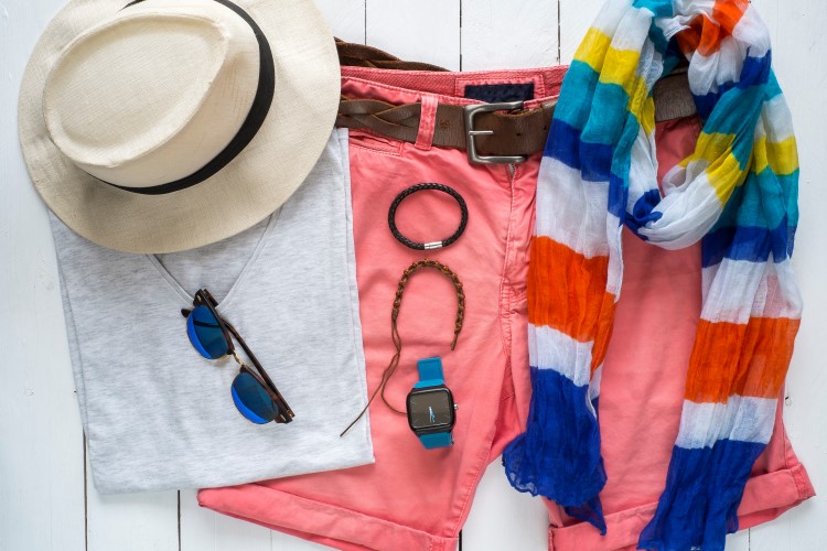 Overhead view of essentials casual travel outfit. Summer clothing, urban clothes. Essentials for traveling light.